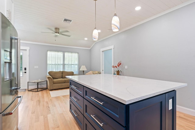 kitchen with crown molding, blue cabinetry, light wood-style flooring, a kitchen island, and stainless steel fridge