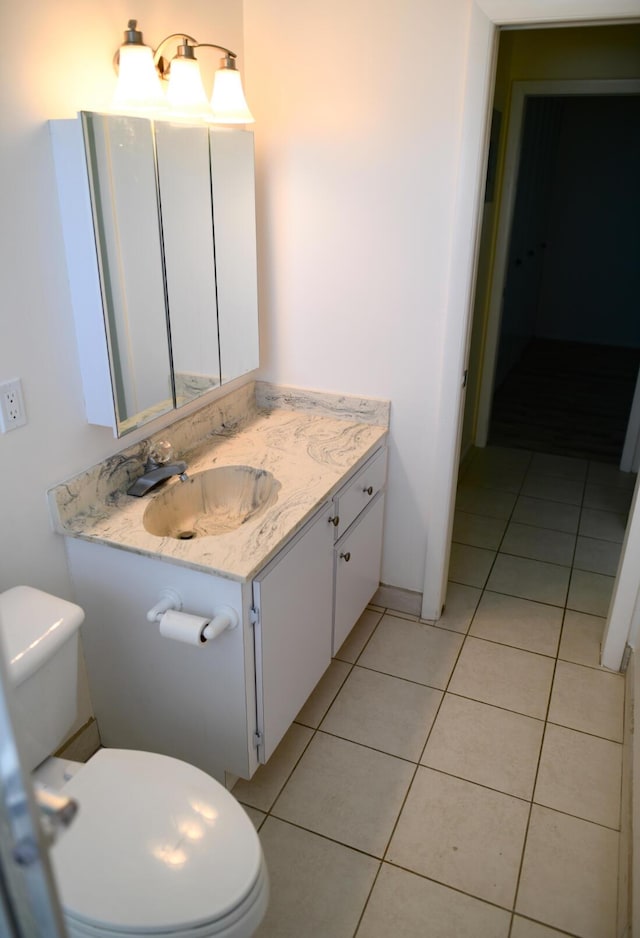 bathroom featuring tile patterned flooring, vanity, and toilet