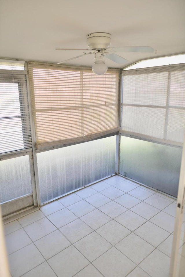 unfurnished sunroom featuring ceiling fan