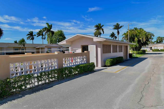 exterior space with fence and stucco siding