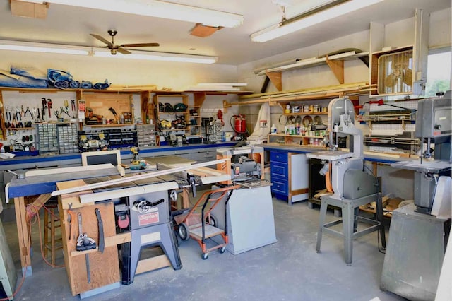 misc room with concrete flooring, a ceiling fan, and a workshop area