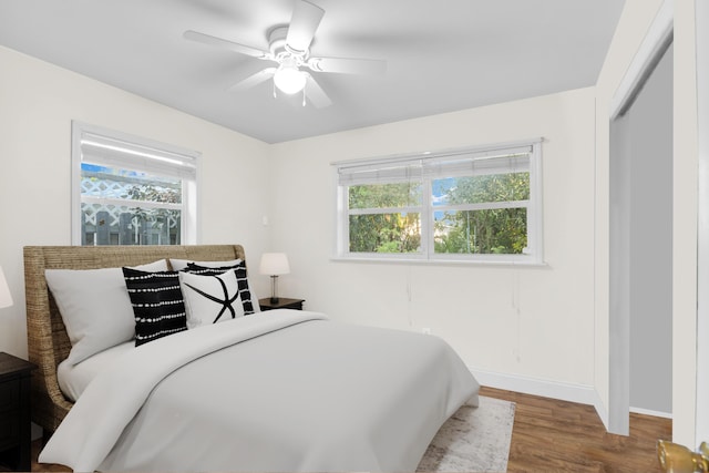 bedroom with baseboards, a ceiling fan, and wood finished floors