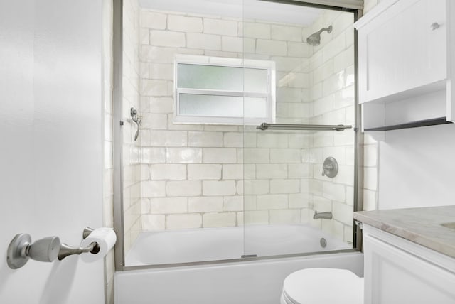 full bath with toilet, bath / shower combo with glass door, and vanity