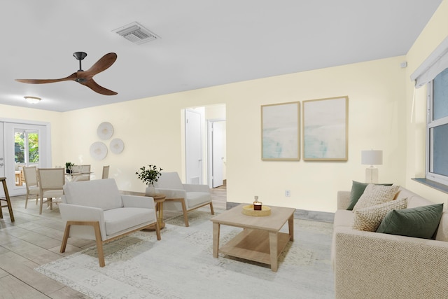 living room featuring visible vents and ceiling fan