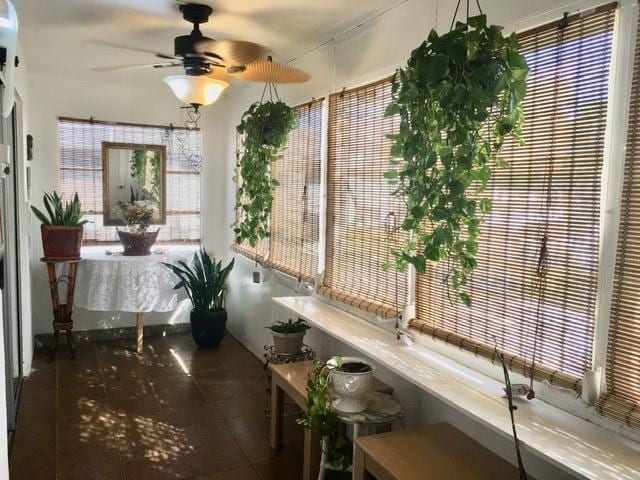 sunroom / solarium with a ceiling fan