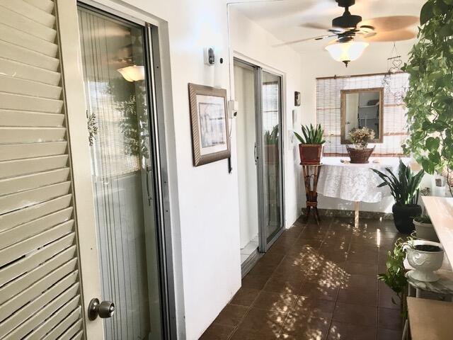 hallway with dark tile patterned flooring