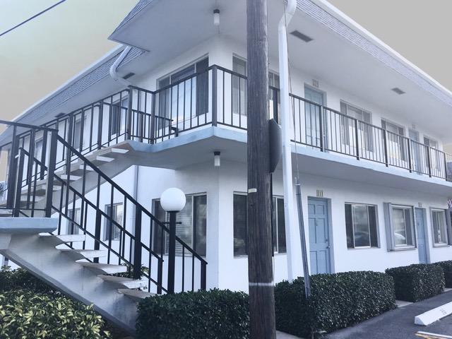 view of property exterior with stairway and stucco siding