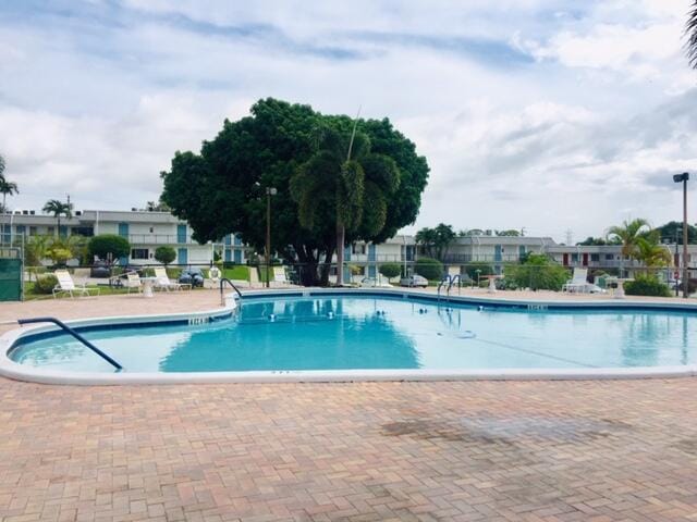 pool featuring a patio area and fence