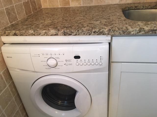 laundry room featuring washer / clothes dryer and a sink