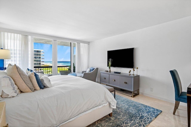 bedroom with access to outside and baseboards