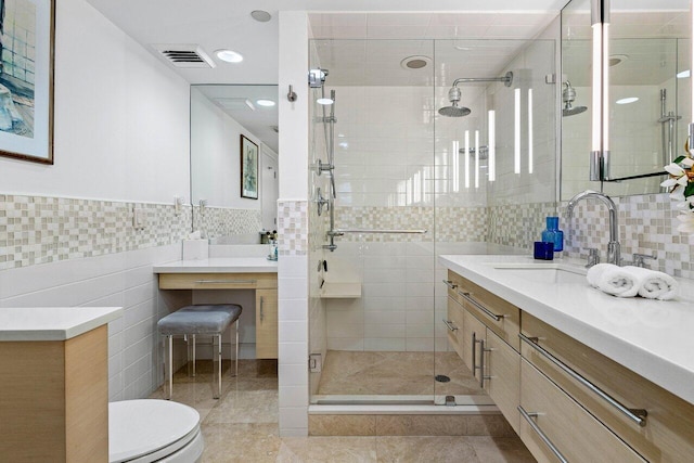 full bathroom with tile patterned flooring, visible vents, vanity, tile walls, and a stall shower