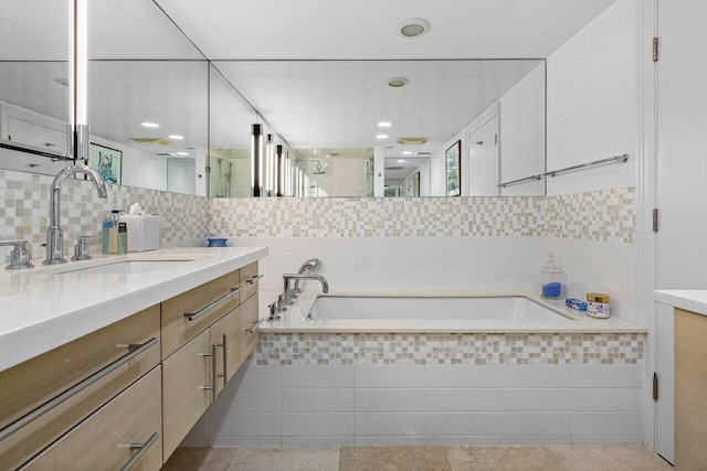 bathroom with tile walls, vanity, a shower stall, a bath, and decorative backsplash