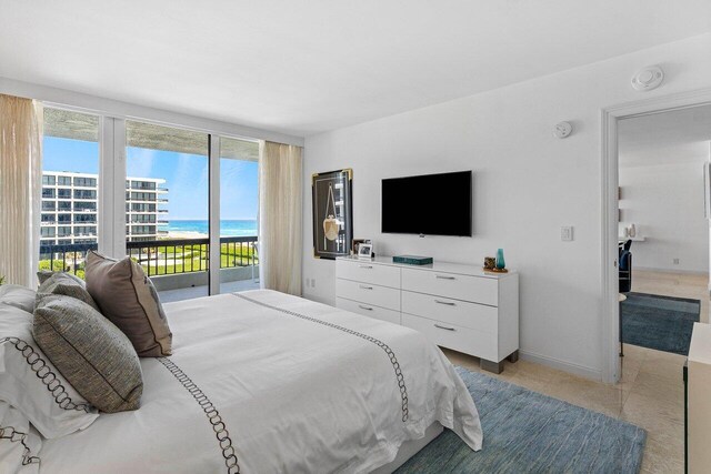 bedroom featuring light tile patterned floors, access to outside, and baseboards