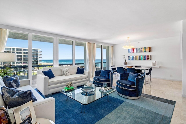 living room with a water view, baseboards, and a wall of windows