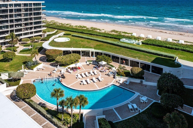 birds eye view of property with a view of the beach and a water view