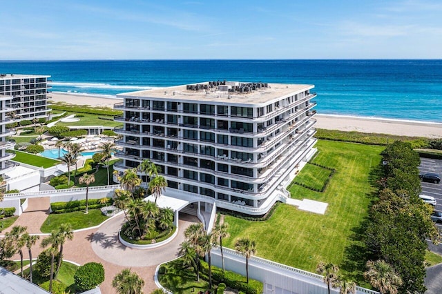 bird's eye view with a water view and a beach view