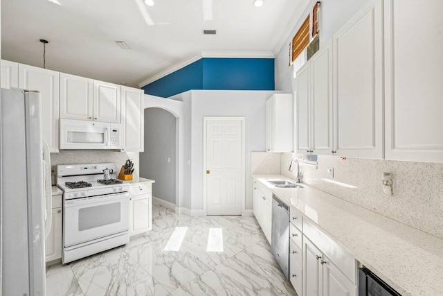 kitchen featuring marble finish floor, ornamental molding, a sink, backsplash, and white appliances