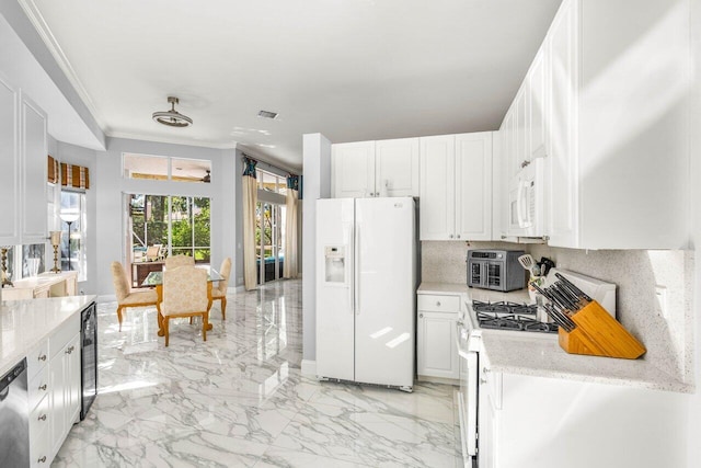 kitchen featuring marble finish floor, ornamental molding, wine cooler, white appliances, and white cabinets