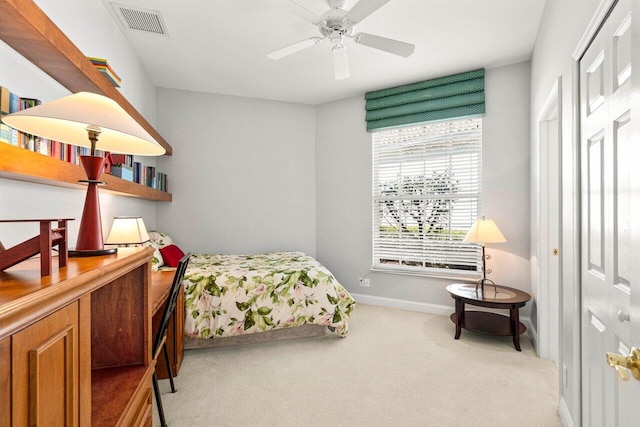 bedroom with visible vents, baseboards, light colored carpet, and a ceiling fan