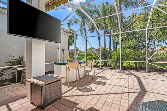 view of patio with glass enclosure