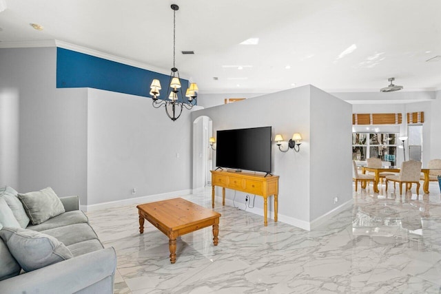 living area featuring arched walkways, marble finish floor, crown molding, and baseboards