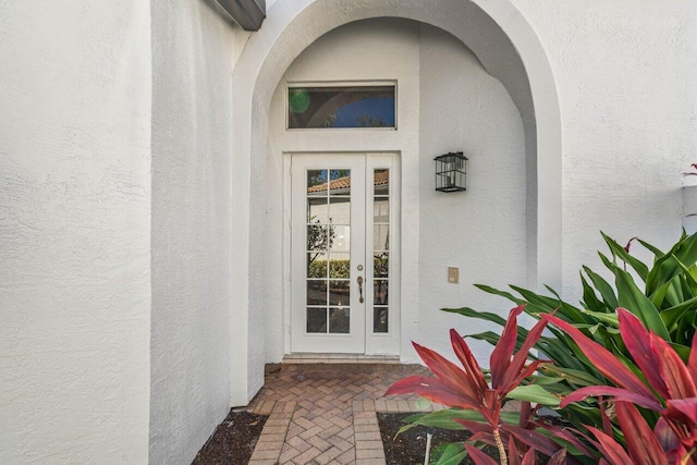 doorway to property with french doors and stucco siding