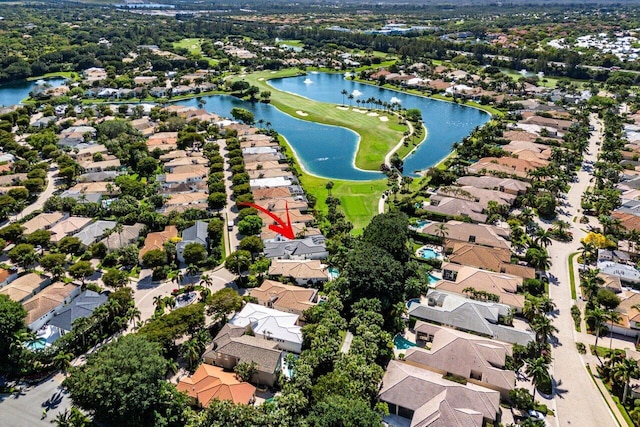 drone / aerial view featuring a residential view and a water view