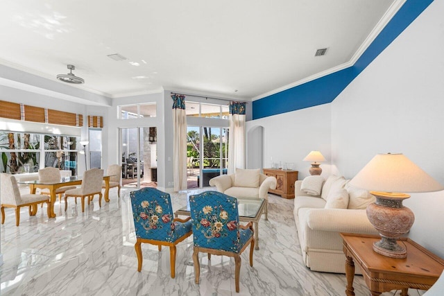 living area with visible vents, arched walkways, marble finish floor, and ornamental molding