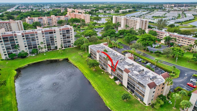 birds eye view of property with a water view and a city view