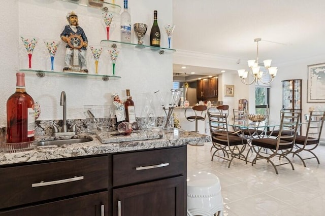 6562 Boca Del Mar Dr Unit 321, Boca Raton, FL 33433 - kitchen featuring dark brown cabinets, pendant lighting, freestanding refrigerator, a notable chandelier, and a sink
