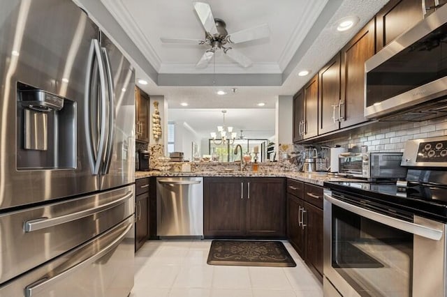 6562 Boca Del Mar Dr Unit 321, Boca Raton, FL 33433 - kitchen with ceiling fan with notable chandelier, appliances with stainless steel finishes, crown molding, decorative backsplash, and a raised ceiling