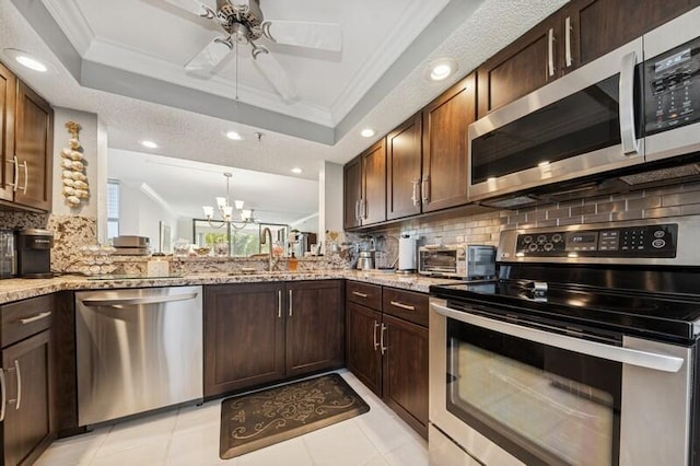 6562 Boca Del Mar Dr Unit 321, Boca Raton, FL 33433 - kitchen featuring crown molding, stainless steel appliances, and a raised ceiling