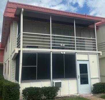 rear view of house featuring a sunroom