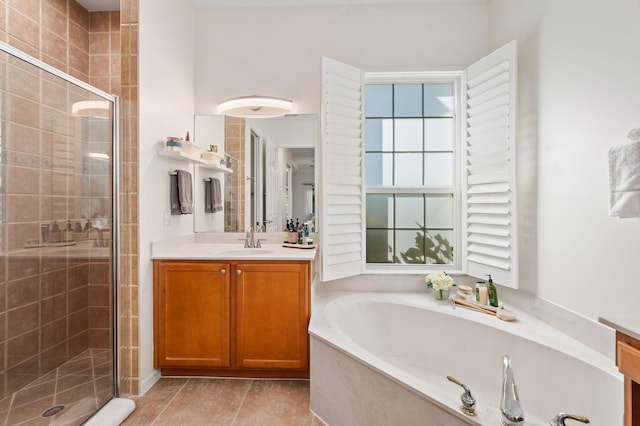 bathroom featuring a shower stall, a bath, and vanity