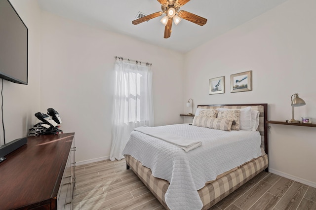 bedroom featuring ceiling fan, wood finish floors, and baseboards