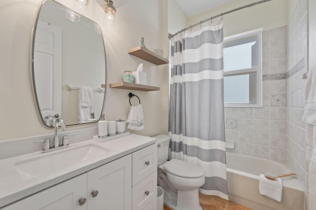 full bath with shower / bath combo, vanity, and toilet