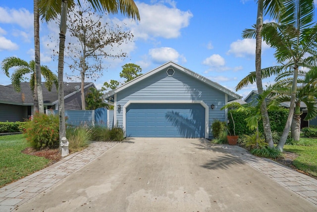 garage featuring concrete driveway