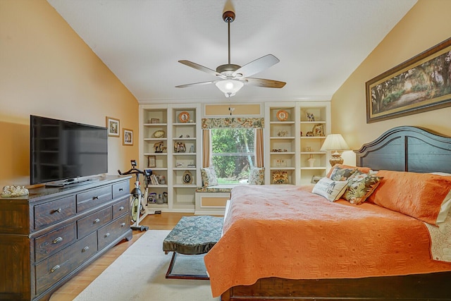 bedroom with lofted ceiling, ceiling fan, and light wood finished floors