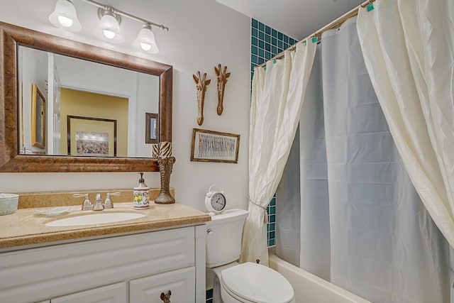 full bath with vanity, toilet, and shower / bath combo with shower curtain