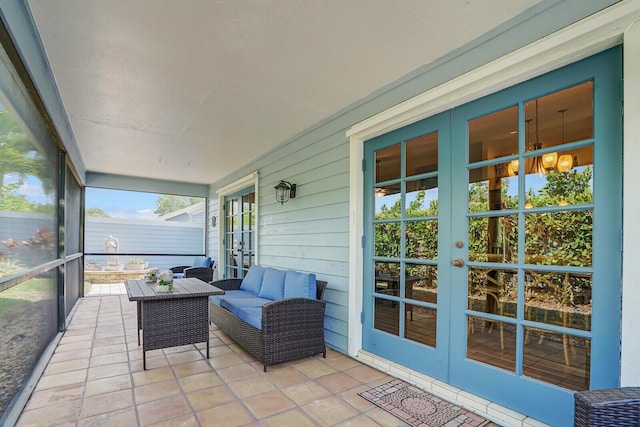 sunroom / solarium featuring french doors