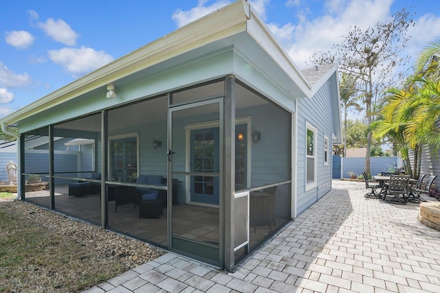 exterior space with a sunroom and a patio area