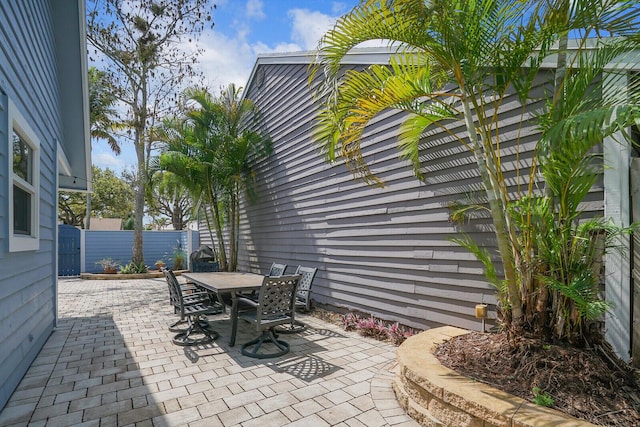 view of patio with outdoor dining space and fence