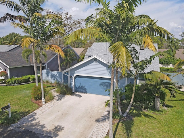 view of front facade with a front lawn, driveway, and an attached garage