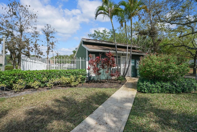 bungalow with a front yard and fence