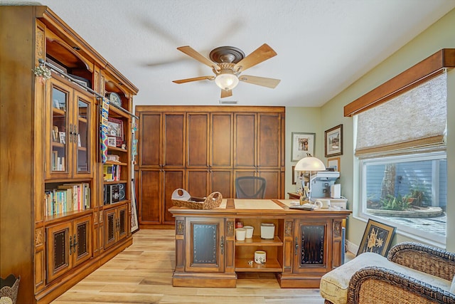 office featuring light wood finished floors and a ceiling fan