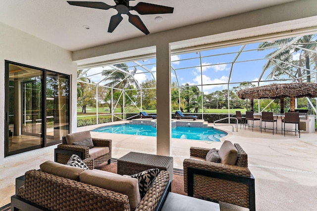 outdoor pool featuring a patio area, an outdoor hangout area, a lanai, and ceiling fan