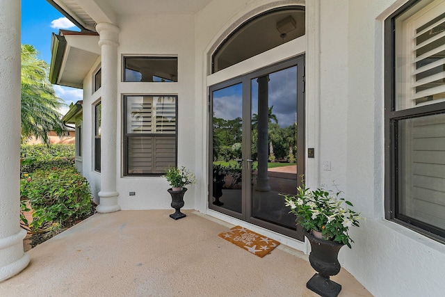 property entrance with stucco siding