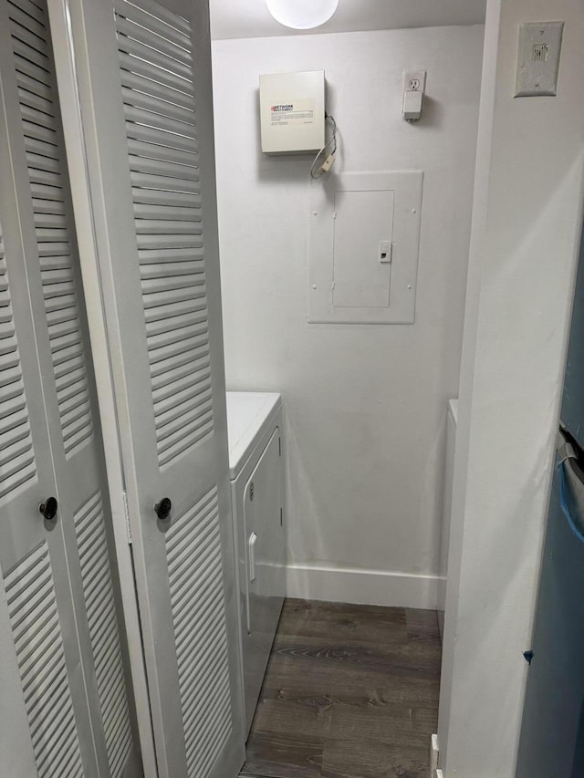 laundry room with laundry area, electric panel, baseboards, dark wood finished floors, and washer and dryer