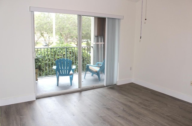 entryway featuring baseboards and wood finished floors