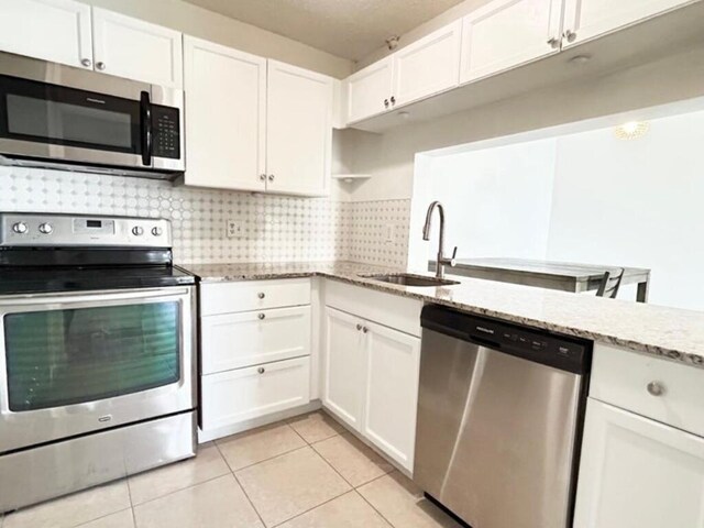 full bathroom featuring visible vents, tiled shower, toilet, tile patterned flooring, and vanity